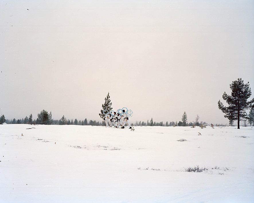 Figures crossing open snow-covered tundra, Rendalen
